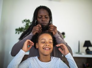 Mother styling daughters hair