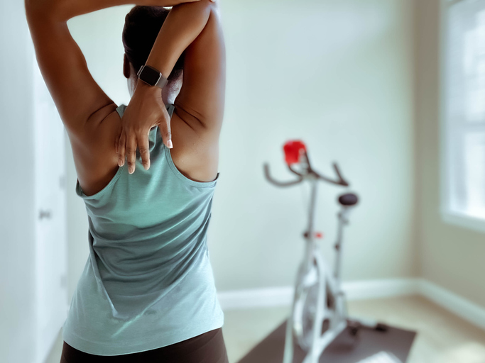 Rear View of Woman Stretching After Indoor Cycling