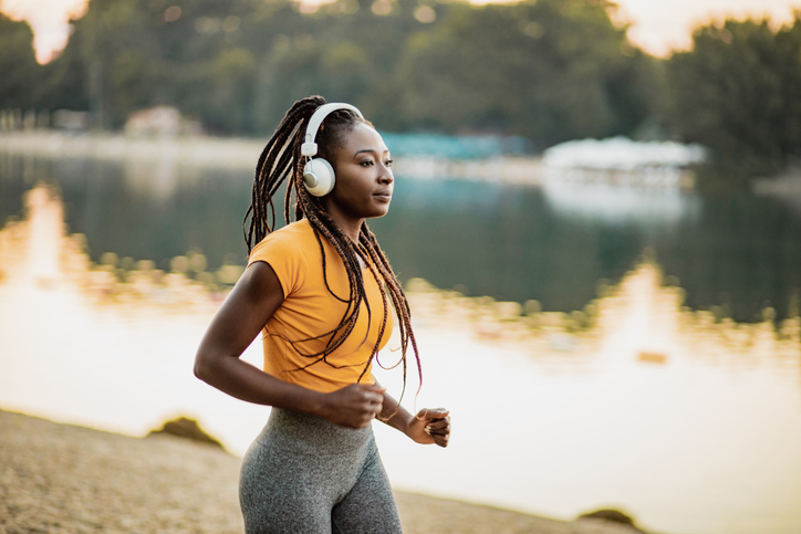Athletic woman with headphones running