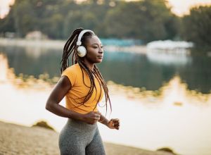 Athletic woman with headphones running