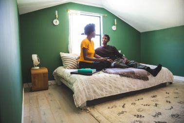 Afro-american couple on lockdown at home watching a movie on TV