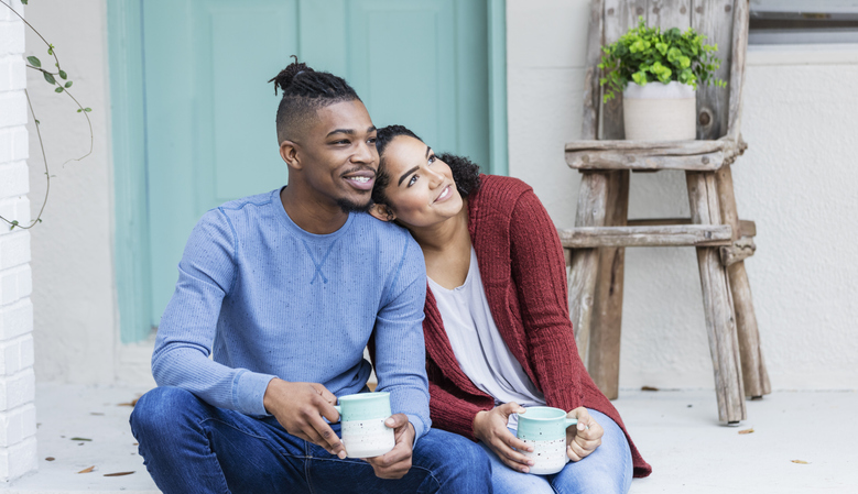 African-American couple hanging out, drinking coffee