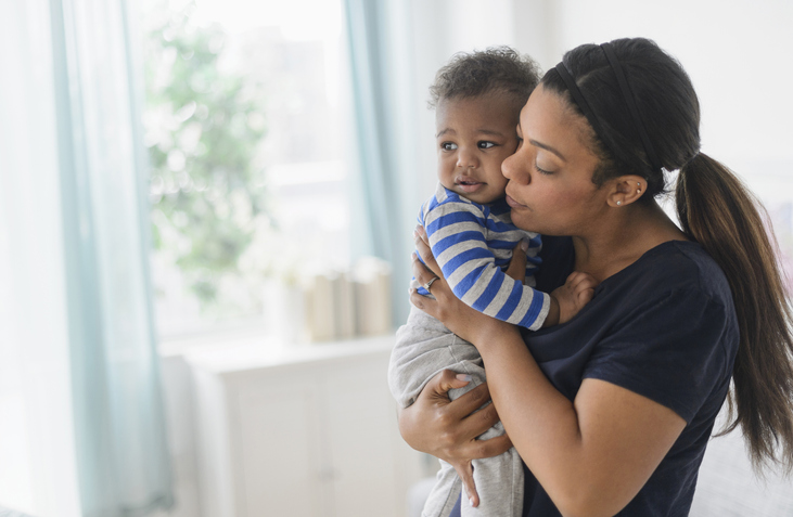 Mixed race mother comforting upset baby son