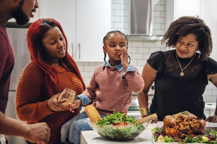 Multi-generation ethnic family preparing Thanksgiving dinner