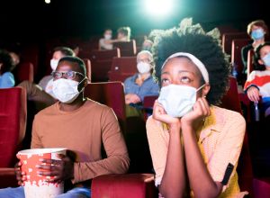 African-American couple watching a movie at the cinema during Covid-19 pandemic