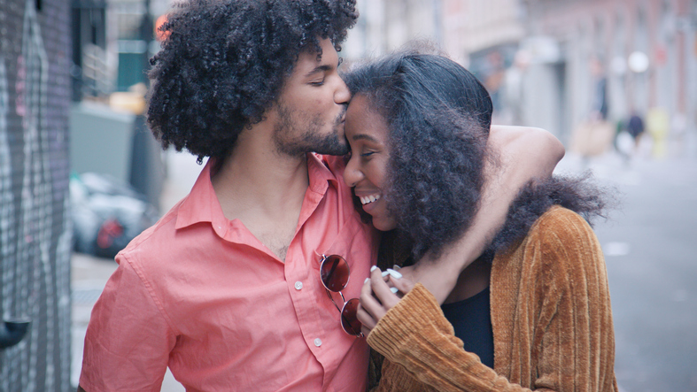 Attractive African American Couple Walk and Kiss on Urban Street