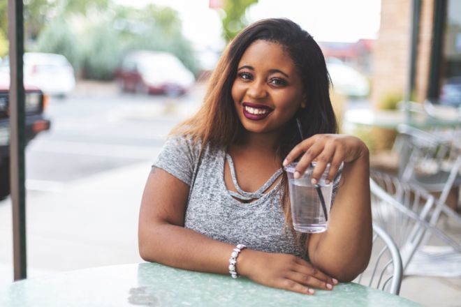 Young College Age Ethnic Female At An Outdoor Bistro Shop