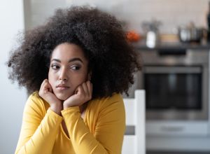 Depressed afro woman at home