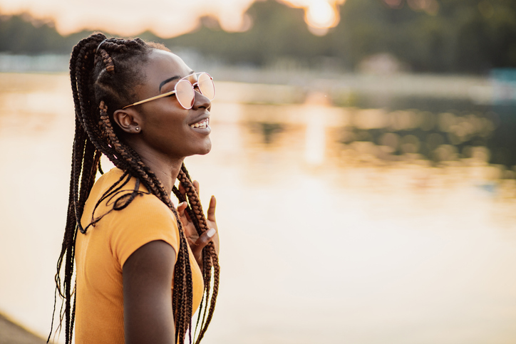 Young woman is relaxing by the river