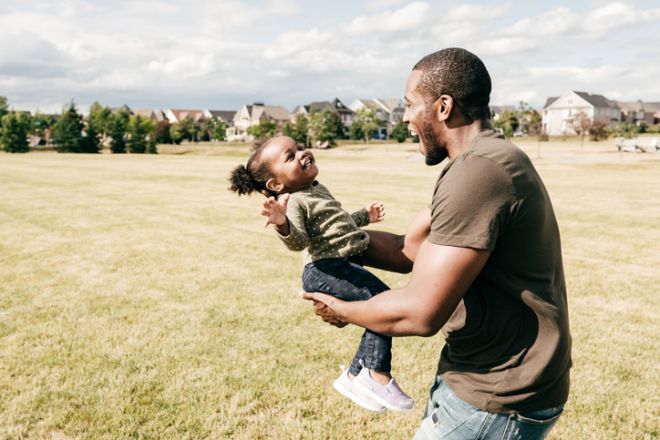 Smiling dad having best time with baby daughter outdoor