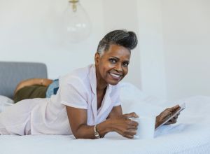 Portrait of beautiful mature woman in bed