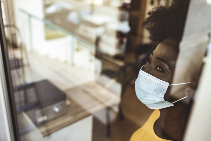 Pensive woman in front of the window