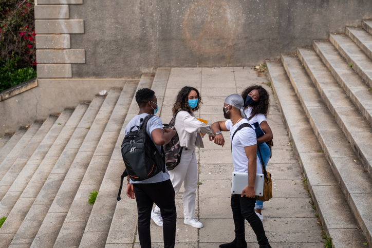 College students return to campus wearing protective masks