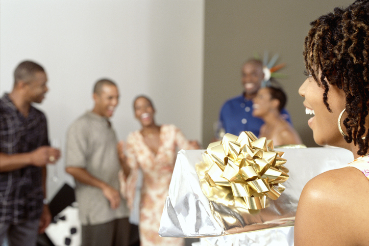 Woman Opening Present During a Party