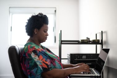 Woman at home using laptop