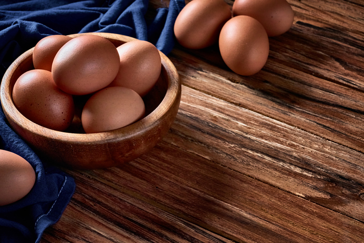 Group of raw eggs on rustic wooden table