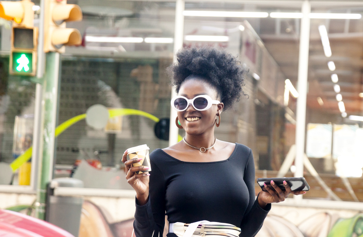 Young woman on street using smartphone