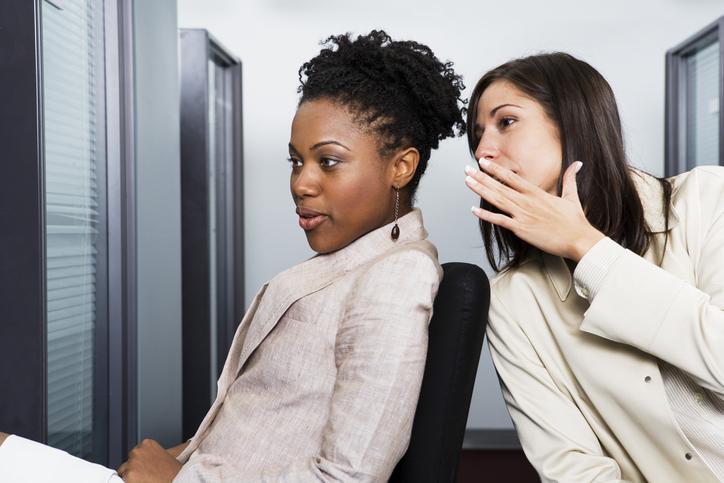 Co-Workers Gossiping in Office