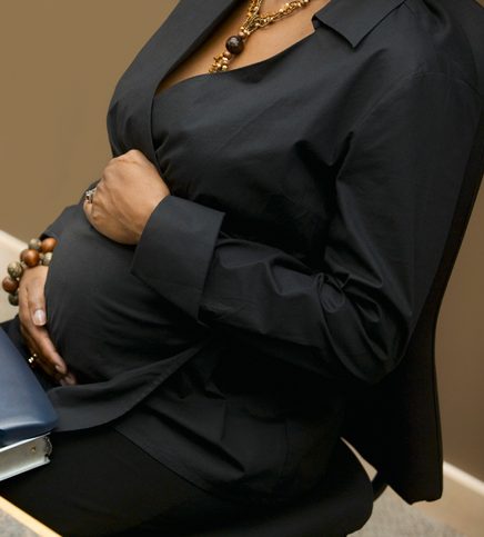 Pregnant Businesswoman Sitting at Computer