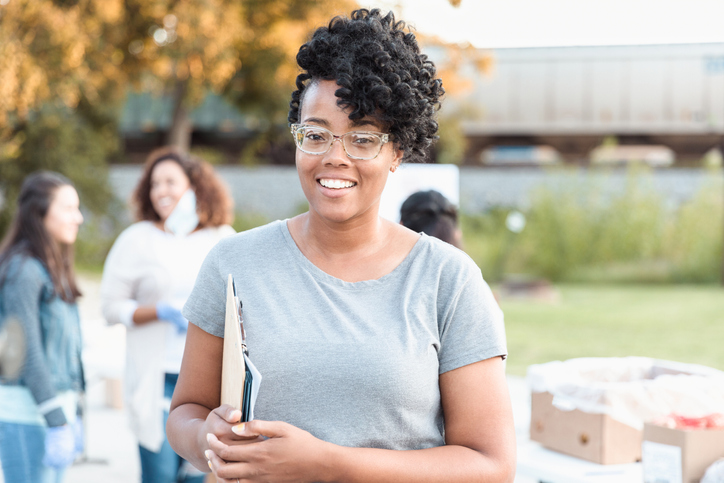 Portrait of young adult female food drive organizer