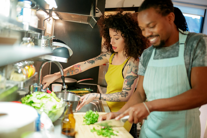Mixed race couple preparing meal