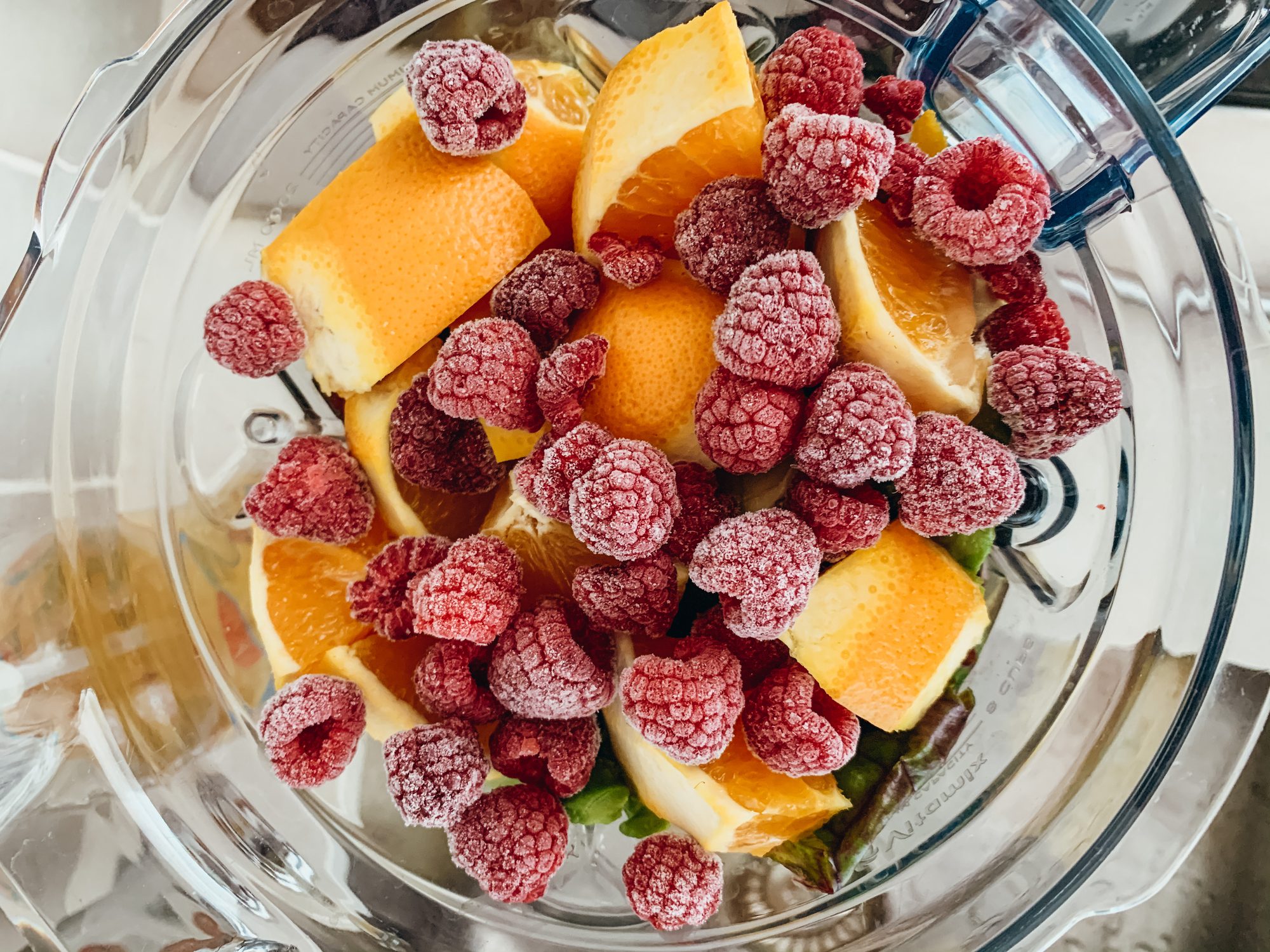 Oranges and Raspberries in Green Smoothie
