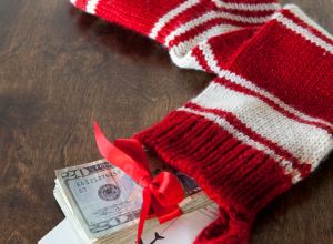 Christmas stocking with airline tickets and cash