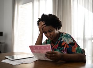 Worried woman looking for financial bills at home