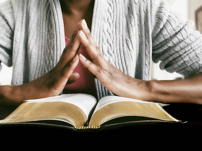 Woman Prays While Reading Scripture
