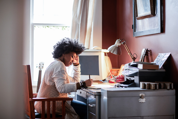 Portrait of a Black woman with cool hair in home office