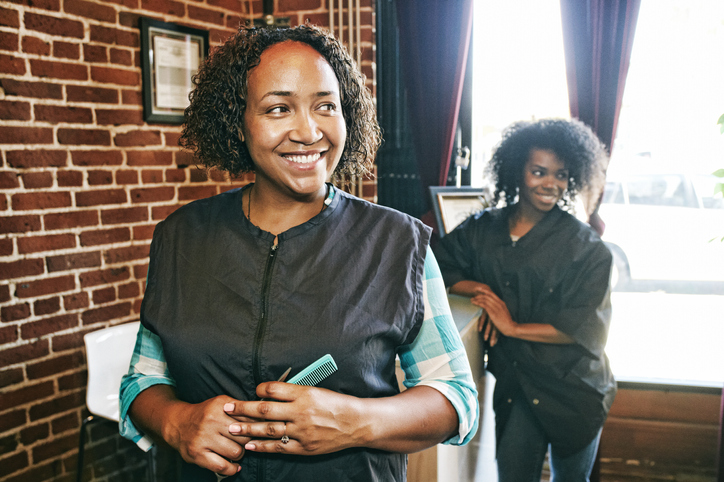 Smiling hairdressers in hair salon