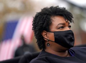 Stacey Abrams wearing mask at political rally was disparaged by a football coach who ended up losing his job over his comments