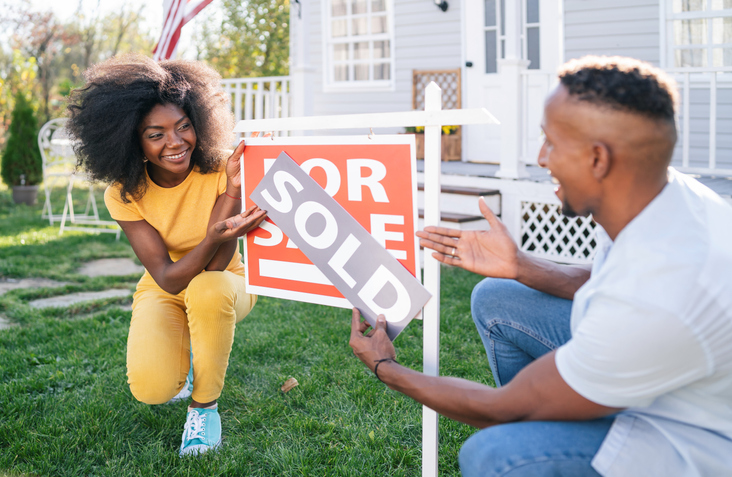 Young afro couple buying a new house