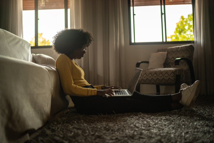 Teenager girl using laptop at home