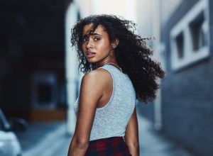Black woman looking over her shoulder walking in city streets