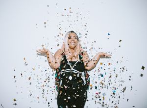 Generation Z Young Woman Celebrates With Confetti