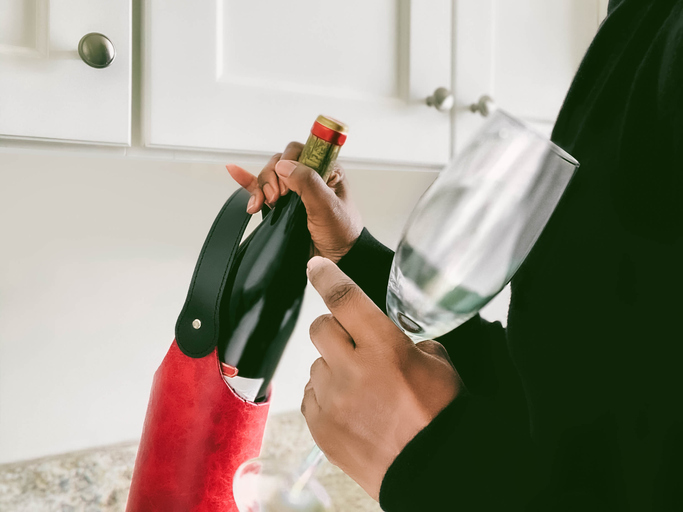 Woman Pulls Out Bottle of Red Wine