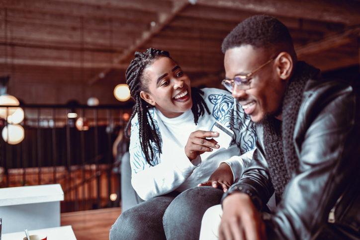 Smiling African Couple Happy With Their Credit Card Purchase