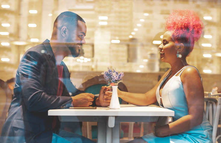 Young beautiful afro couple having romantic dinner
