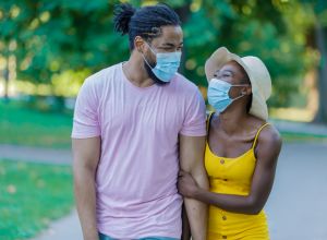 Happy African-American Man is Walking in the Public Park with His Lovely Wife During Time of Virus.