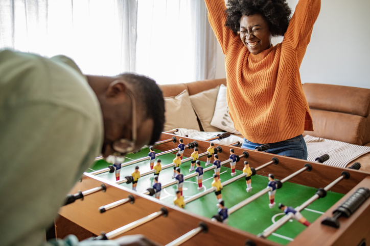 Friends having fun and playing table football