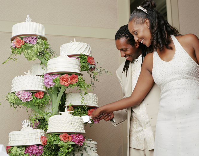 Newlyweds cutting wedding cake