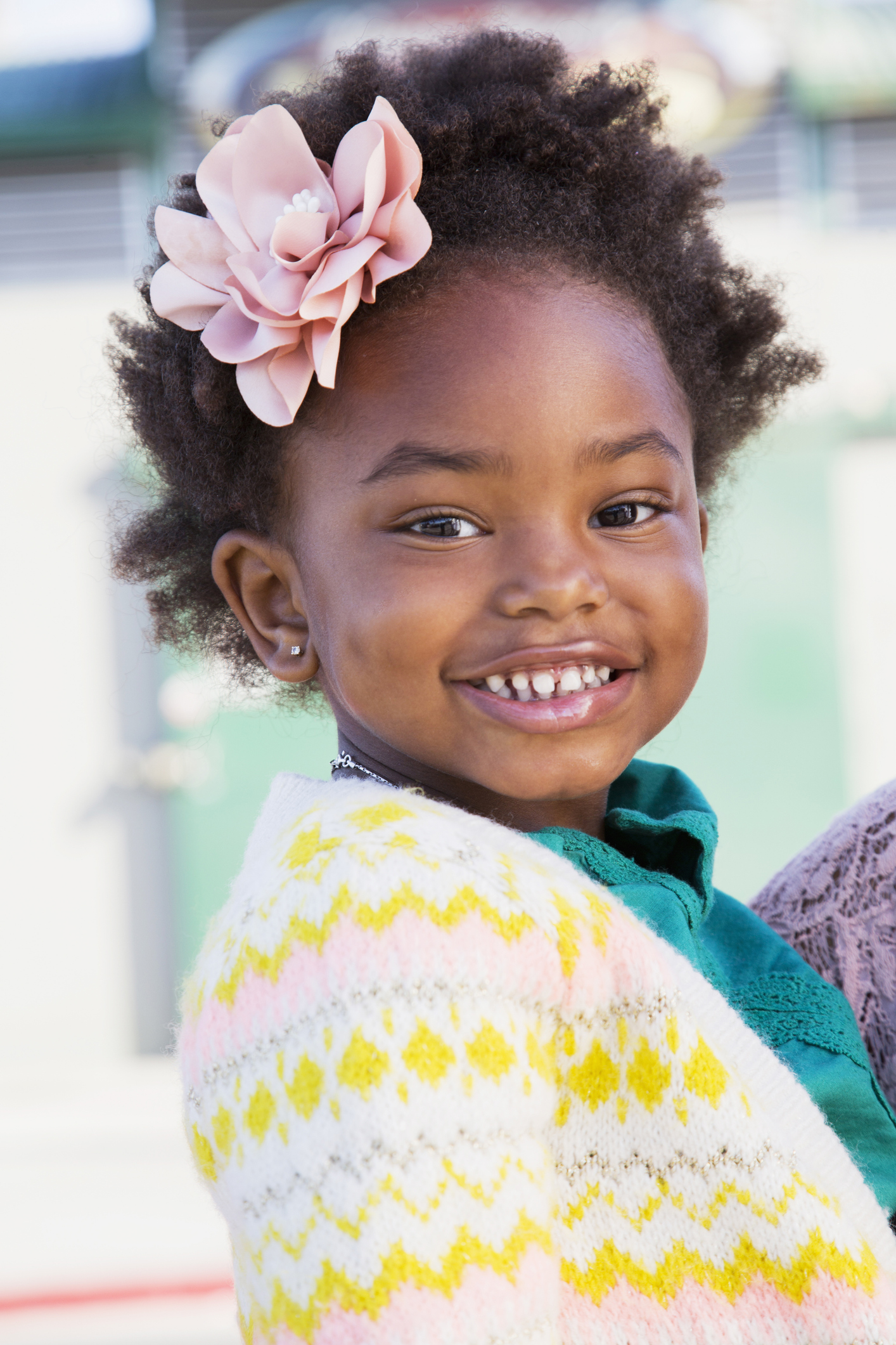 Portrait of smiling black girl with flower in hair