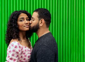 Man Kissing Woman Against Wall