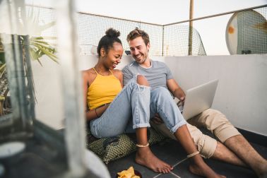 Happy young couple with laptop