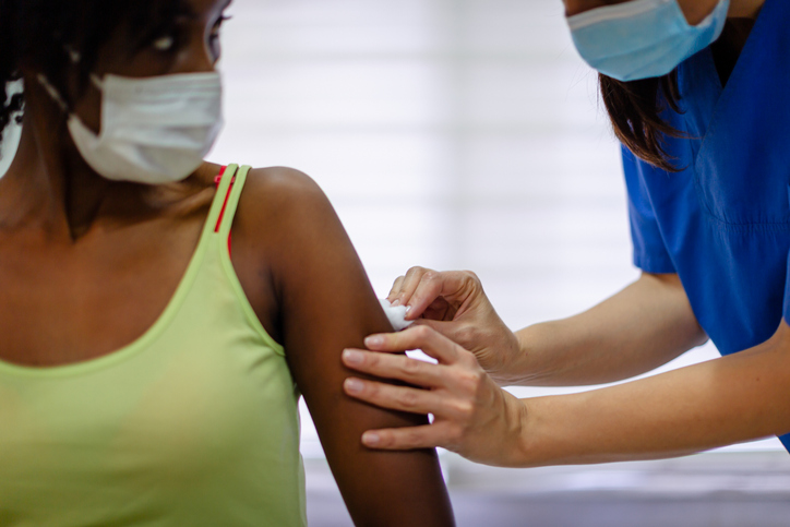 African-American female taking a COVID-19 vaccine
