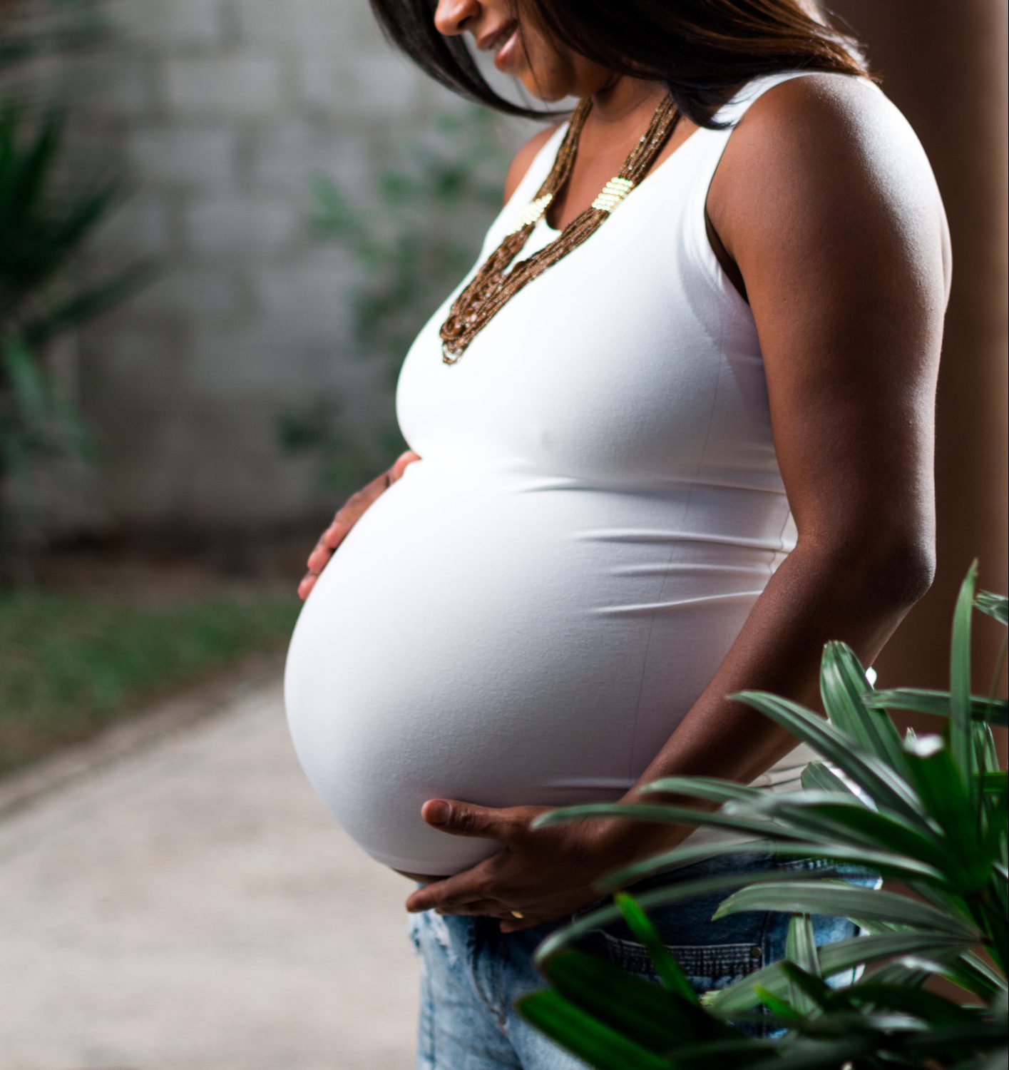 Side View Of Pregnant Woman Standing Outdoors