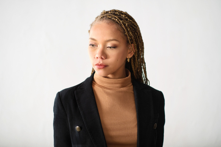 Young businesswoman headshot portrait looking down.