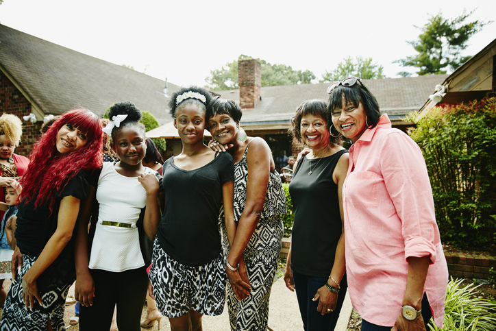 Smiling grandmothers with family during party