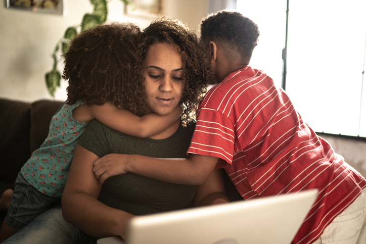 Mother trying to work with kids annoying her at home